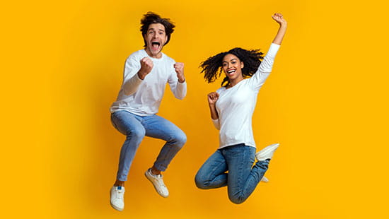 Man and woman jump on bright background