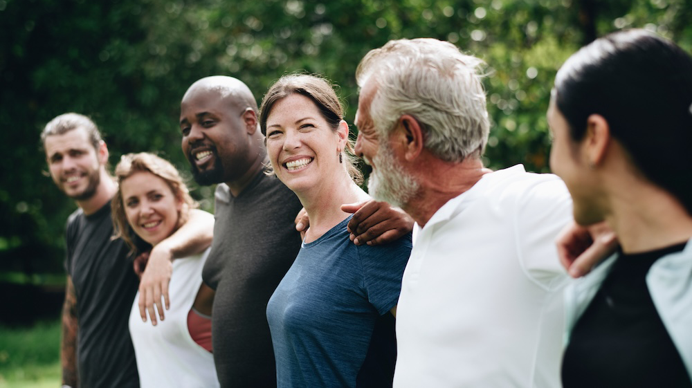 Group of people with arms over each other