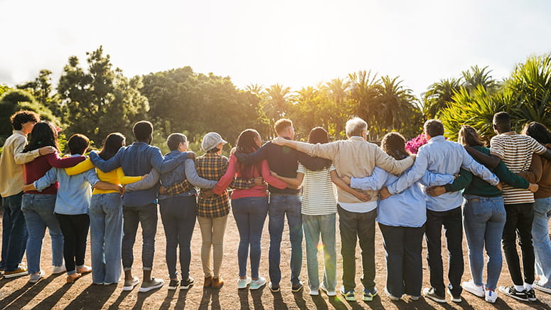 Multigenerational group of people hugging each other