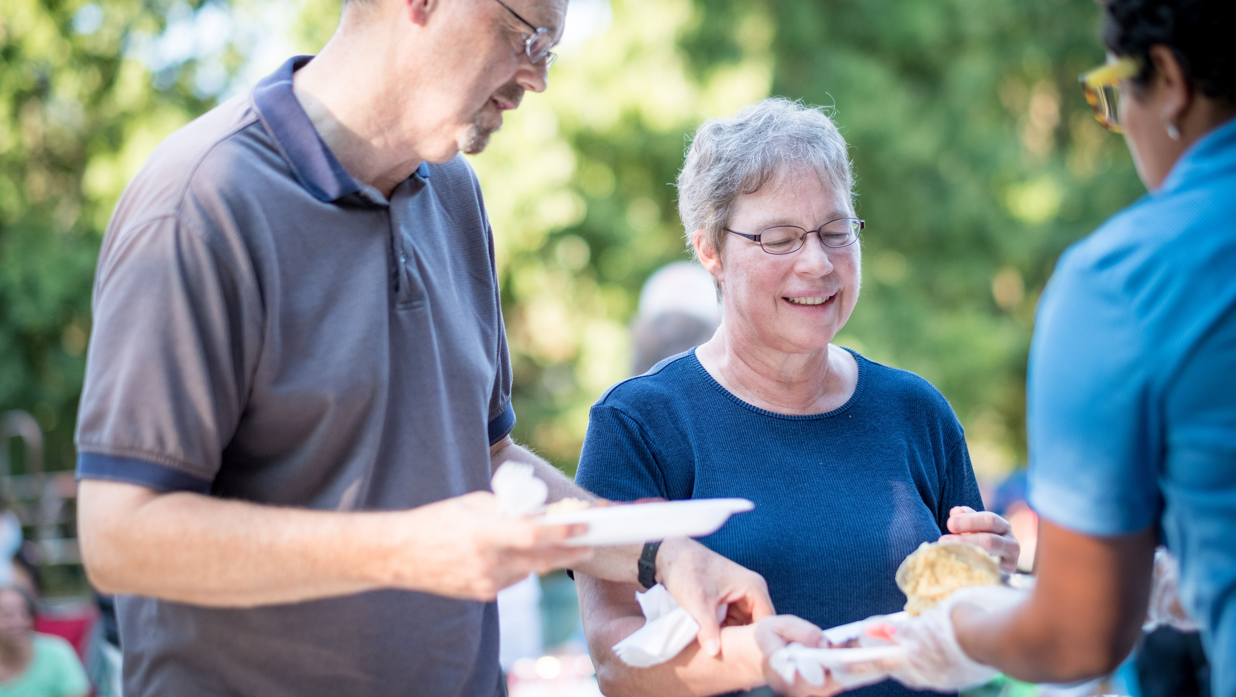 Everence members are served food by an Everence staff person at a client appreciation event in Central Penn.