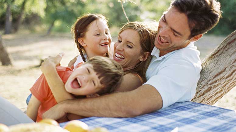 Family laughing together in a group hug