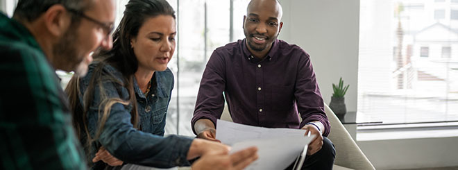 Three-people-meeting-over-financials