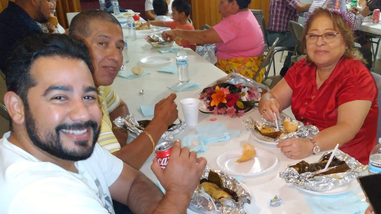 A group enjoys a hot meal provided by Mision Cristiana fe y Compasion in Van Nuys, California.