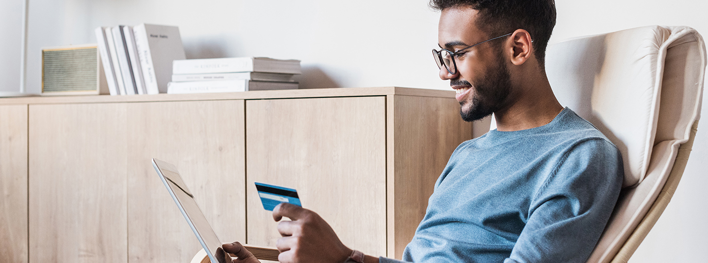 Man using tablet to shop with credit card