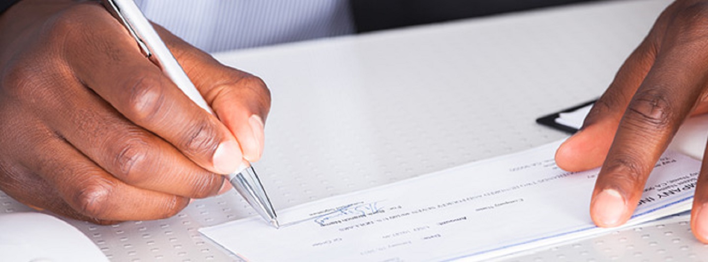 Man signing a check