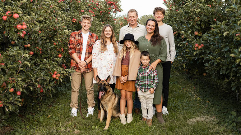 Stoltzfus family photo in an apple orchard