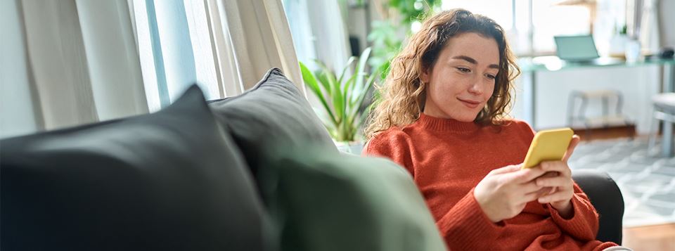 Young woman on phone on couch