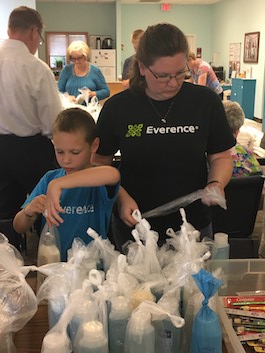 Everence family members, Michelle and Dominic, pack care packages for those in need.
