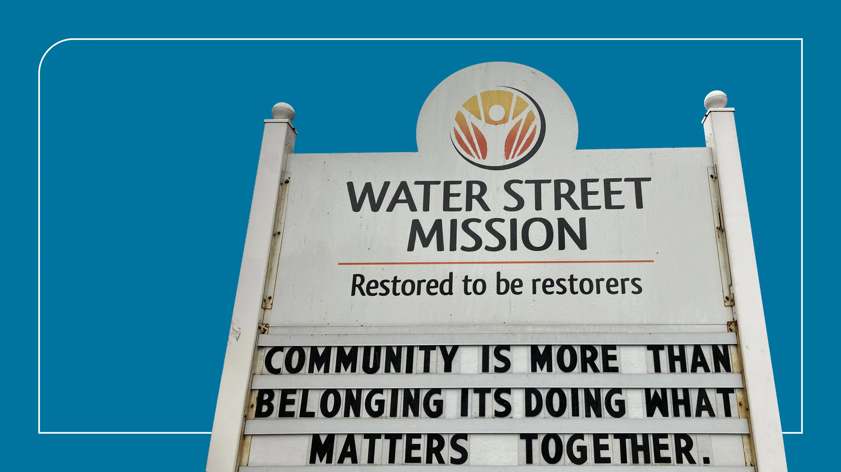 Image of Water Street Mission sign on a blue background.