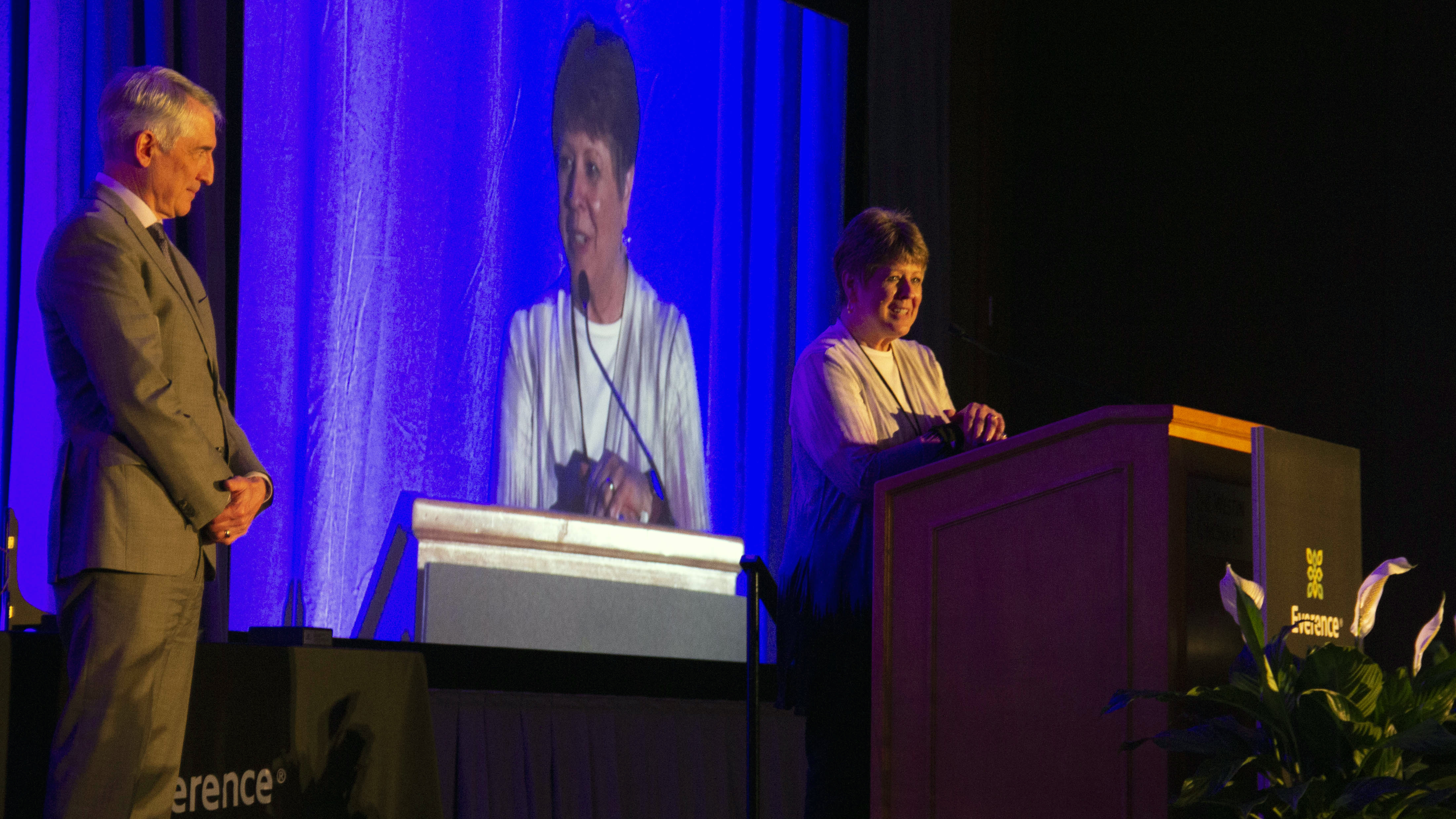 Ken Hochstetler, Everence President and CEO, looks on as Eunice Culp, Vice President of Human Resources, accepts the Stewardship of Culture Award at the 2022 Everence National Conference.