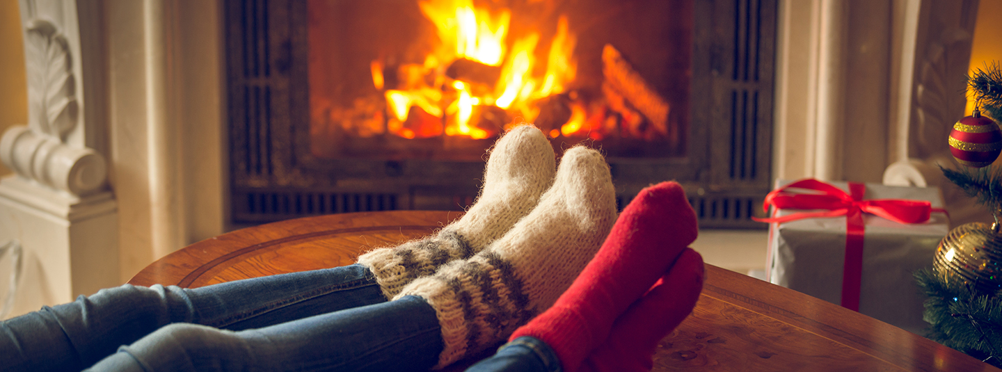 Close up of a couple enjoying a cozy fireplace
