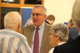 Bill Hartman talking with clients