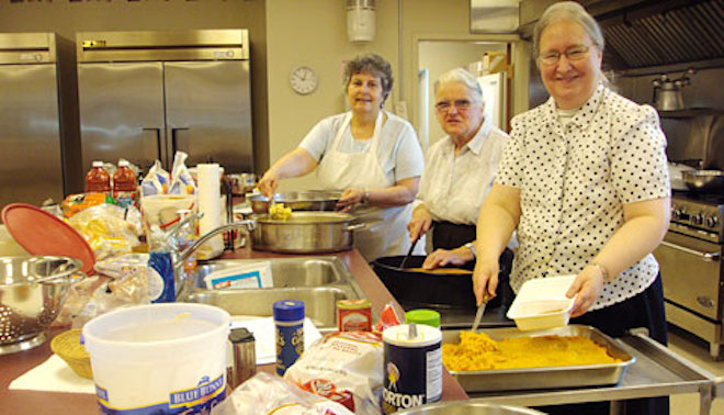 Three women preparing a meal
