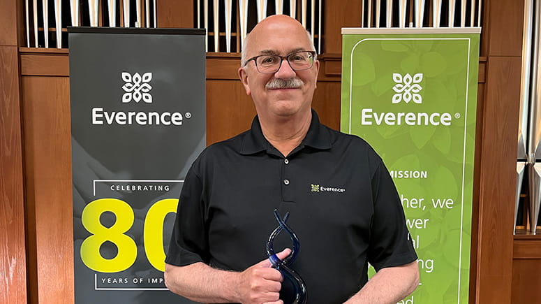 Glen Kauffman holds the award for 2024 Praxis Mutual Funds Sales award.