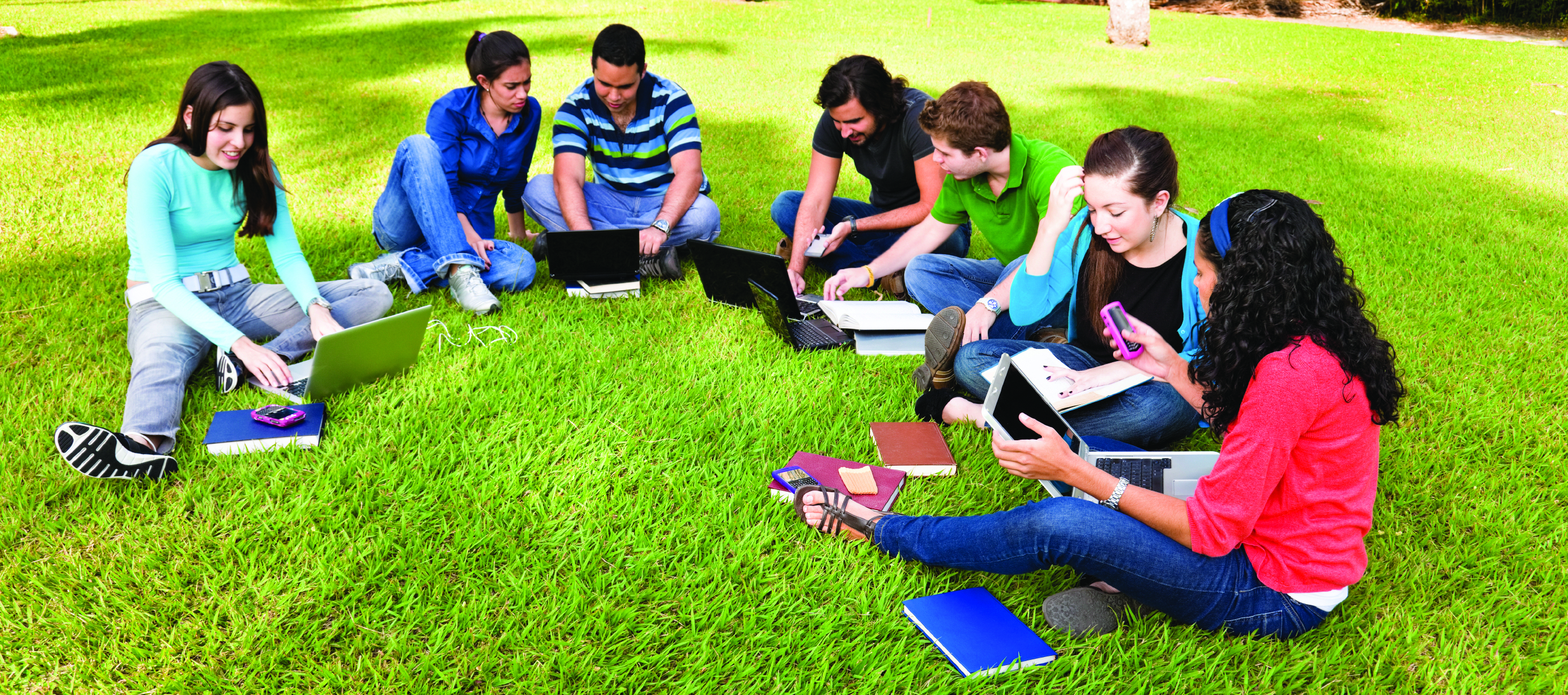 Group of college students studying together outside