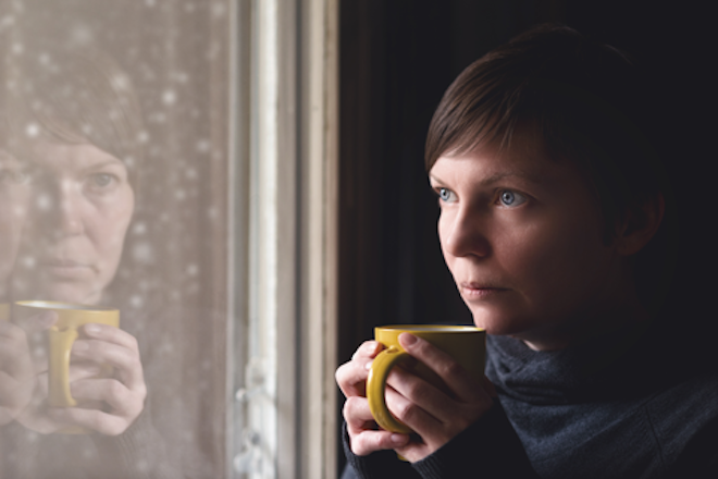 Woman gazing out the window on a rainy day