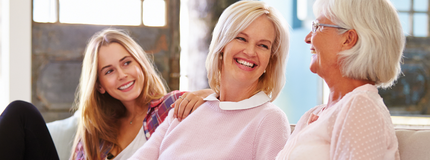 Multi-generational women smiling and laughing together.