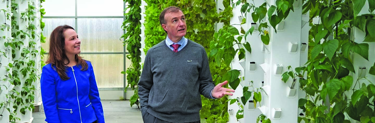 Nikki Shingle and Steve Lindsey walk through the Garden Spot Village greenhouse