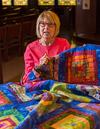 Elaine holding a quilt