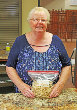 Carolyn holding cooking supplies