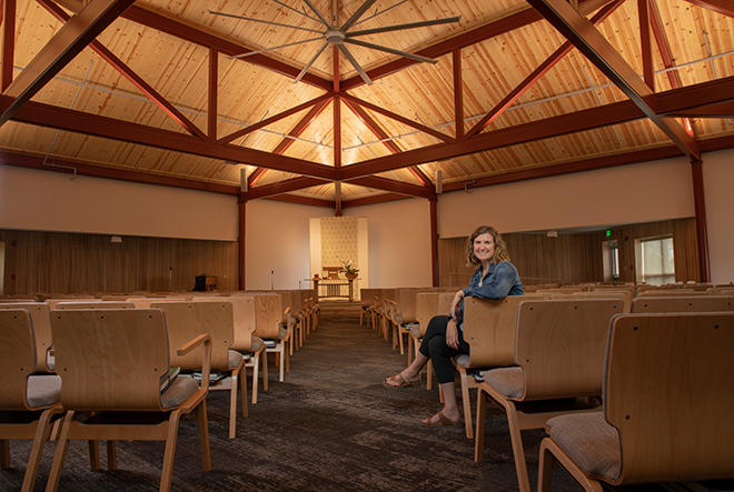 Assembly Mennonite Church Pastor Anna Yoder Schlabach poses in newly renovated sanctuary