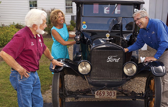 Jay, Glenda and Galen look at old car.