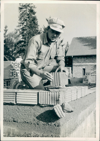 man doing masonry work about 70 years ago
