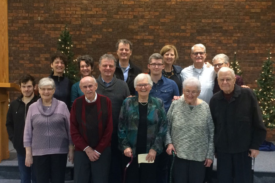 A group photo of a family. In the first row, in the center, are an elderly couple who are being celebrated