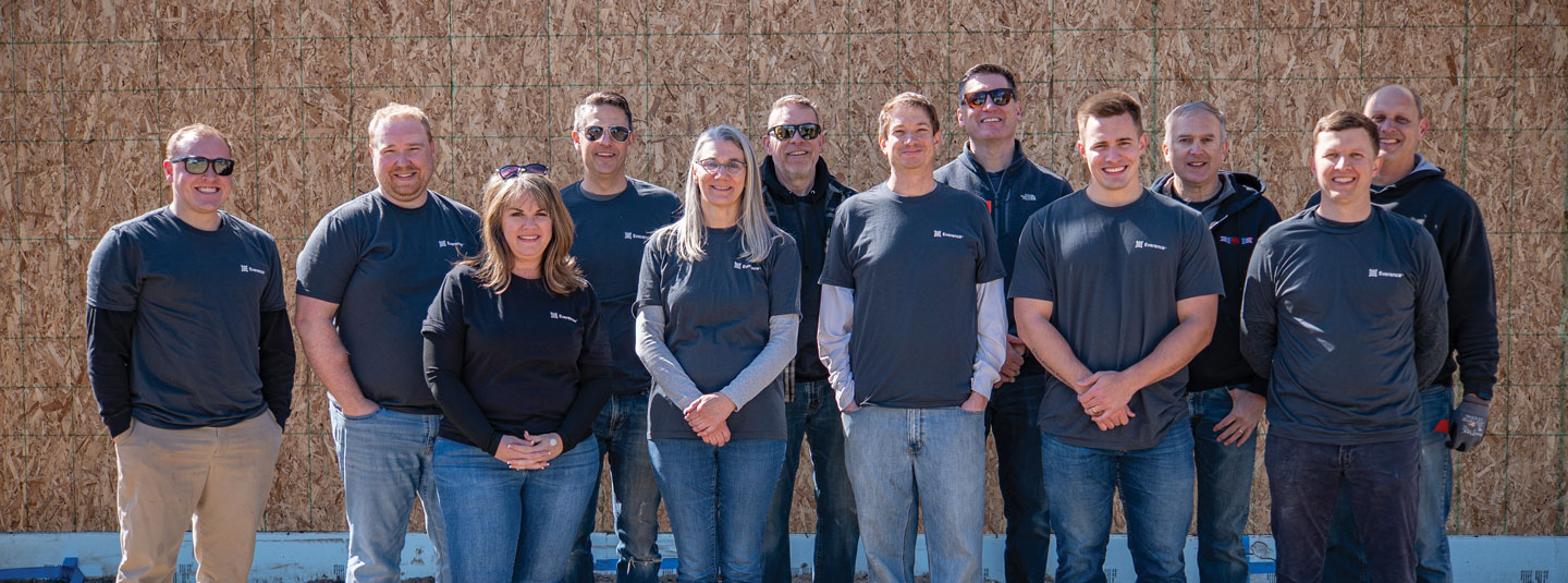 A group of people stand, posing for a group photo