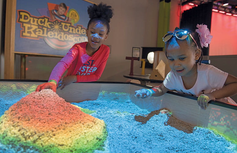 Kids playing at topography table.