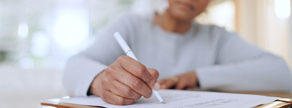 Woman signing a document