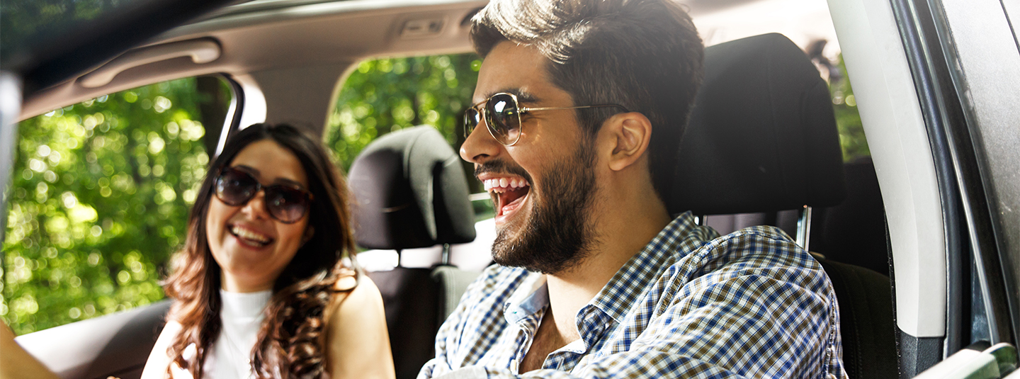 Happy couple driving