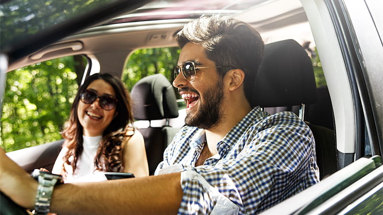 Happy couple driving