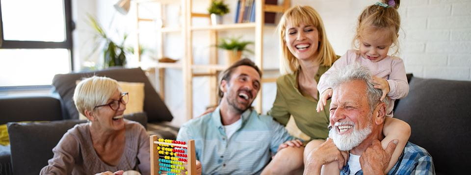A multigenerational family shares love and laughter in the living room.