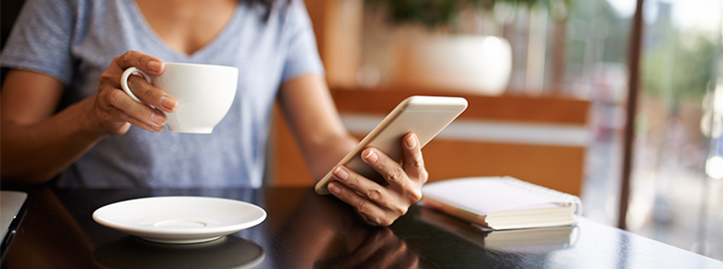 Woman on her phone in a coffee shop