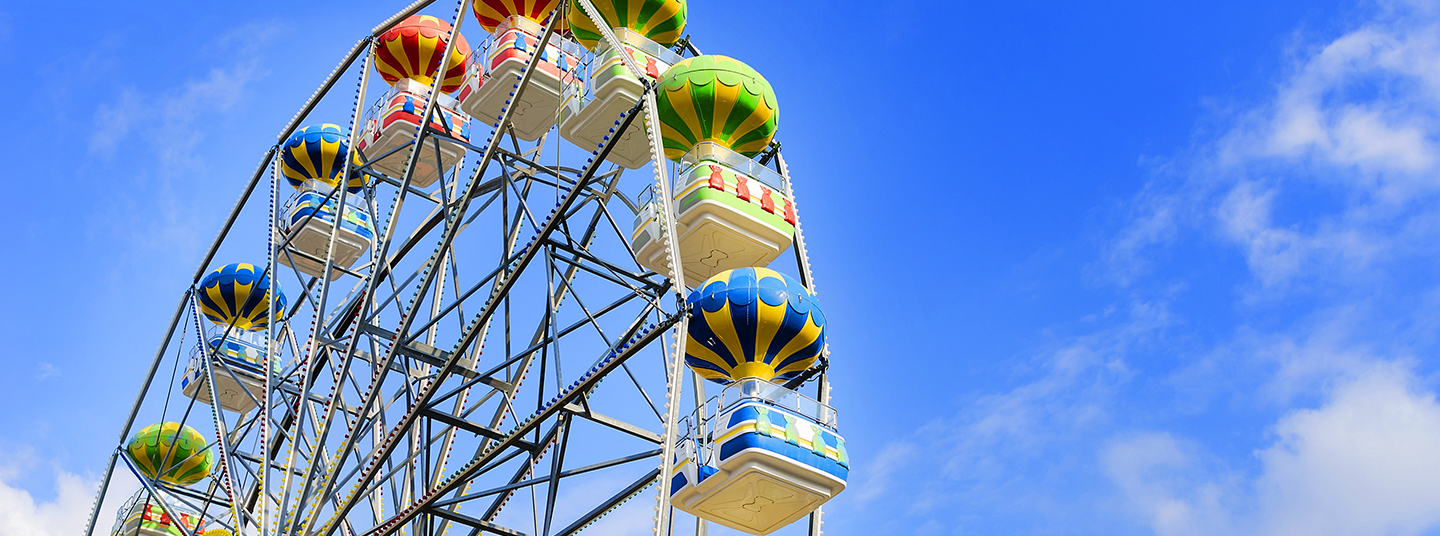 Ferris wheel on the background of blue sky with cloud