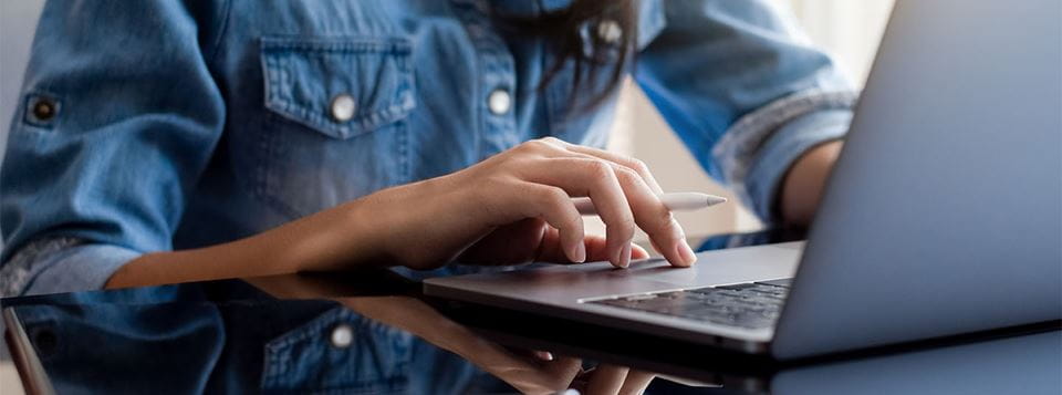 Close up of man using laptop trackpad
