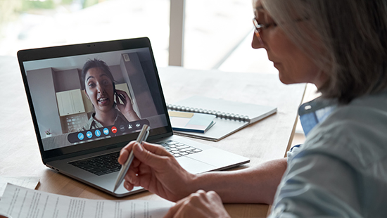 Woman using laptop to video call