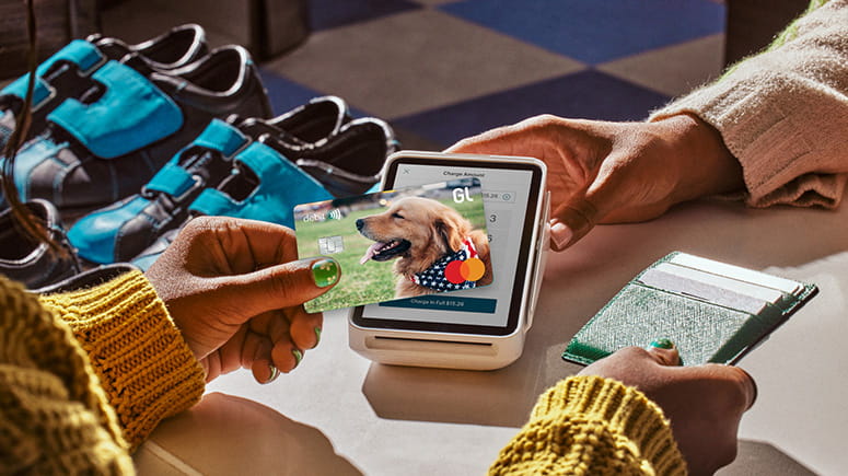 Photo of a girl using a customized Greenlight card for tap to pay