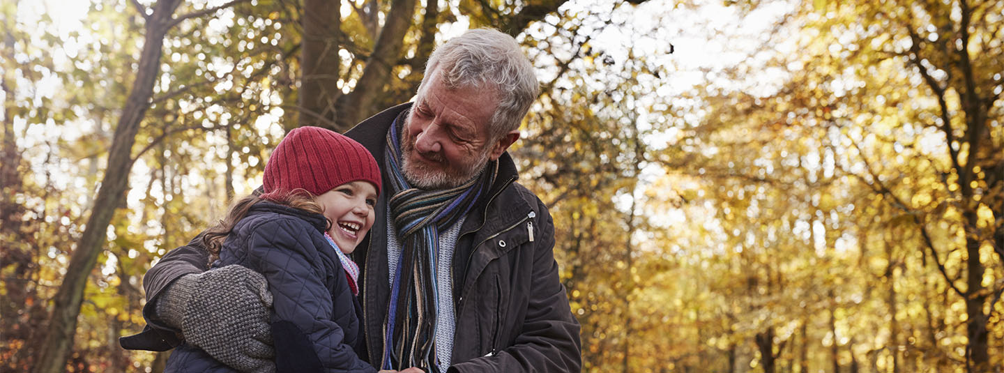 Grandpa with grandchild in autumn 