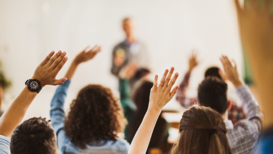 MennoCon23_Proposed-agency-repositioning_Group-raising-hands_550x310