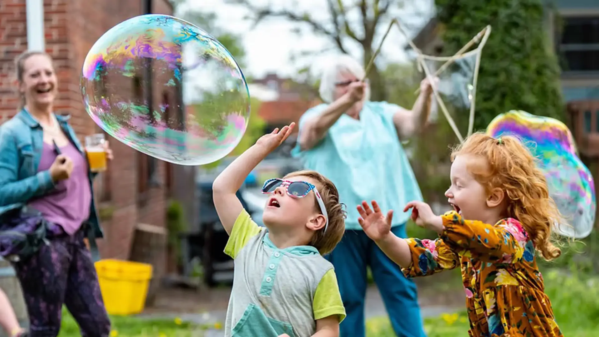 Bubbles by the burg image with kids playing with bubbles.