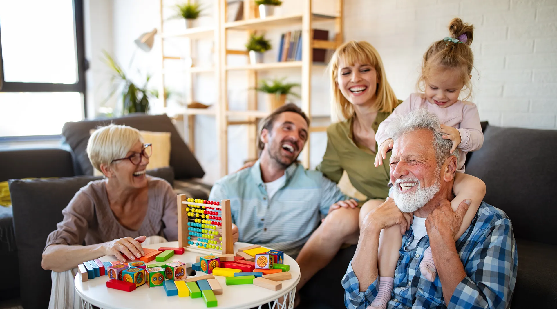 Multi-generational family playing and laughing together.