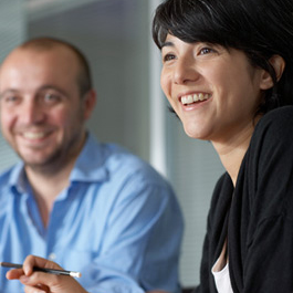 Team members smiling at a meeting