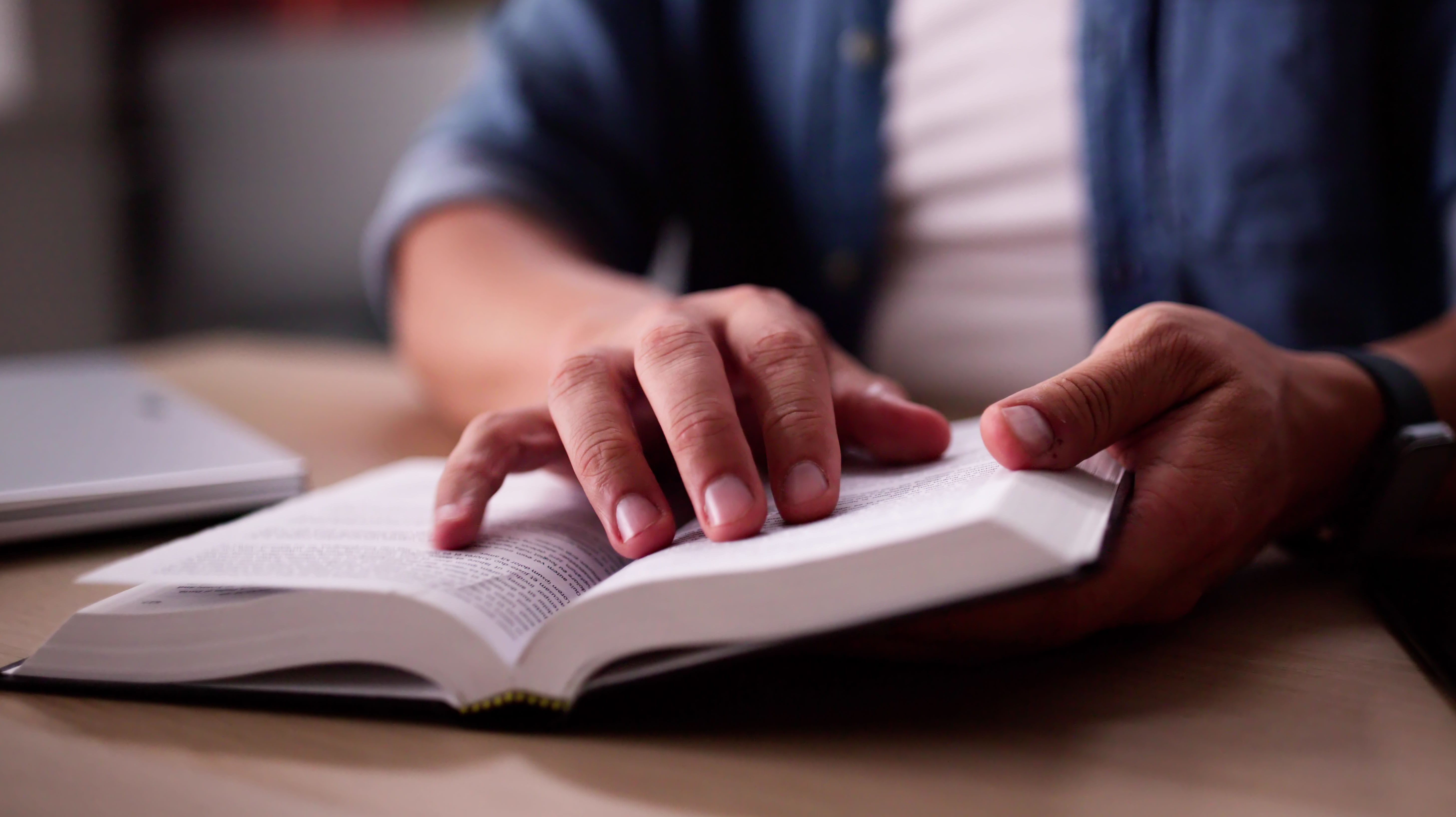 Close-up of man's hands with Bible