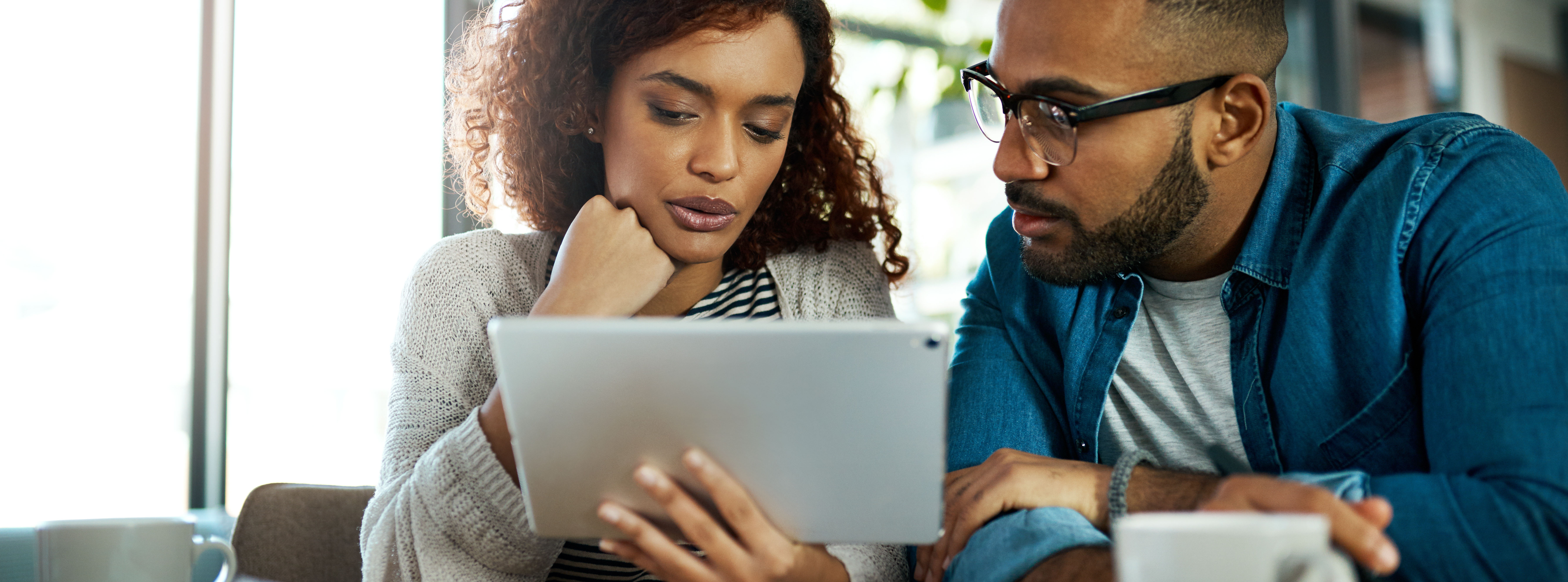 Couple going over finances on a tablet