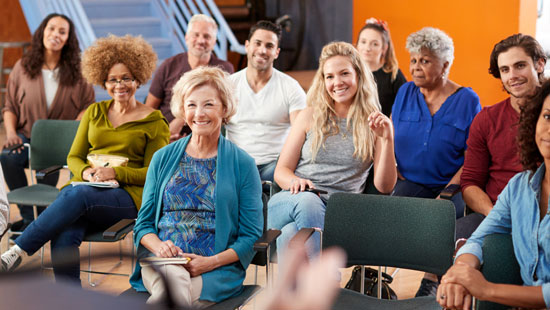 Group of people listening to a speaker