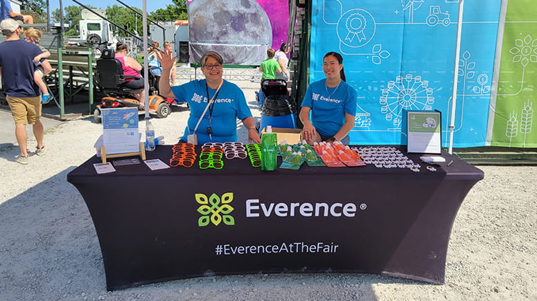 Everence Credit Union staff manning the giveaway table at the Elkhart County 4-H Fair.