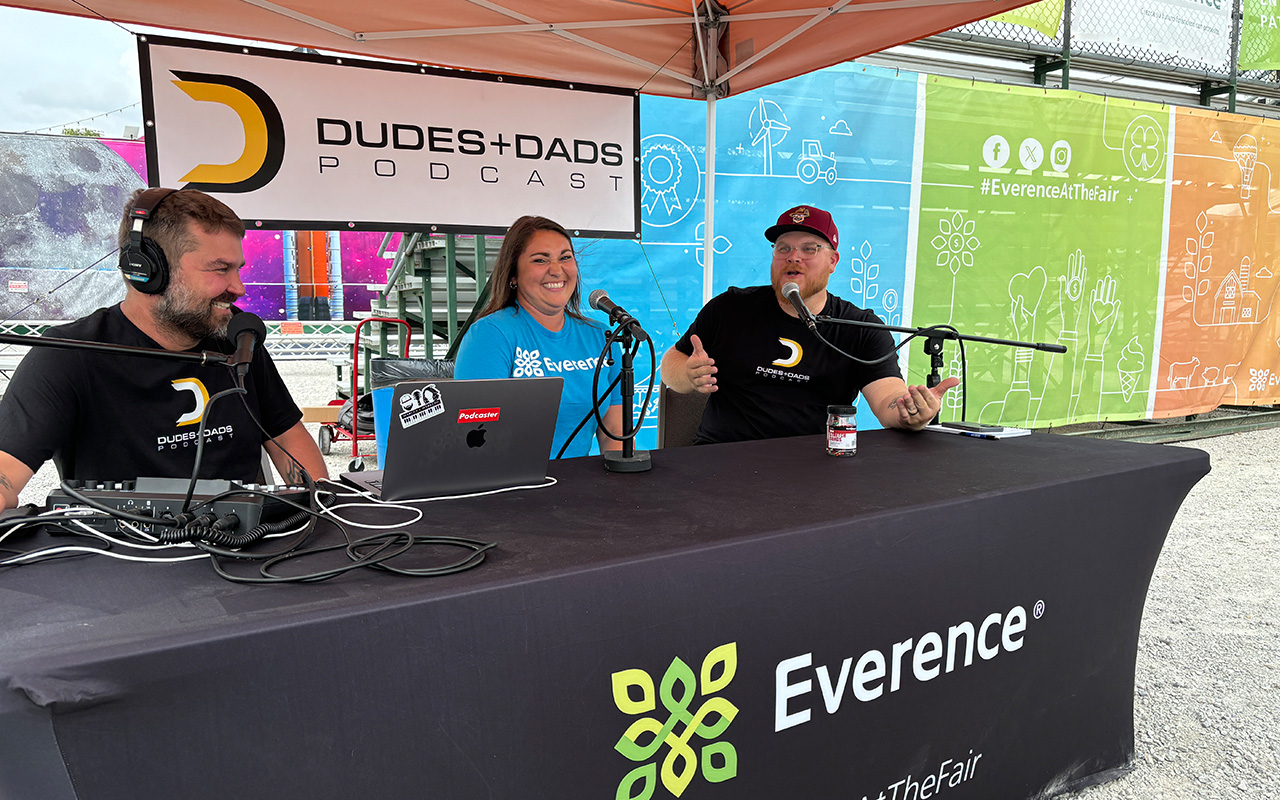 Everence employee, Allison Pletcher, talks with Dudes and Dads podcast hosts, Andy Lehman and Joel DeMott at the Everence Entertainment center at the Elkhart County 4-H Fair.