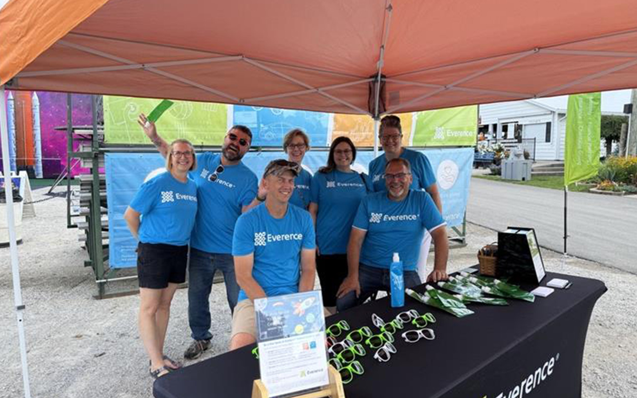 Group of employees poses in front of Everence Entertainment Center at the Elkhart County 4-H Fair.